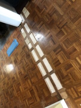 Laying replacement parquet over repaired floor
